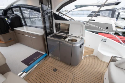 Luxurious 2022 Princess V50 yacht interior with kitchenette and seating area.