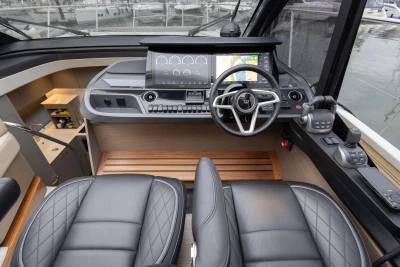 Luxurious 2022 Princess V50 yacht helm with modern controls and leather seating.
