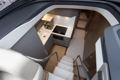 Modern kitchen interior on 2022 Princess V50 yacht, featuring sleek cabinetry and appliances.