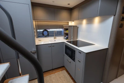 Modern kitchen in 2022 Princess V50 yacht with sleek cabinetry and appliances.