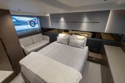 Luxurious bedroom interior of 2022 Princess V50 yacht with modern design and cozy furnishings.