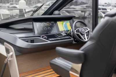 Helm of 2022 Princess V50 yacht with modern navigation displays and steering wheel.