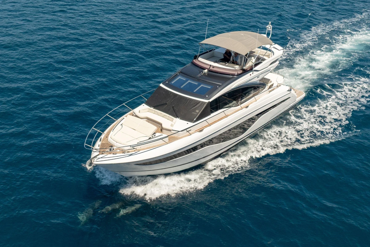 2023 Princess S62 yacht cruising on clear blue ocean waters.