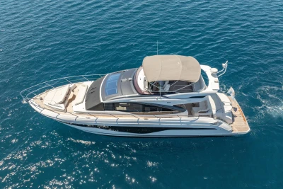 Luxurious 2023 Princess S62 yacht cruising on clear blue waters.