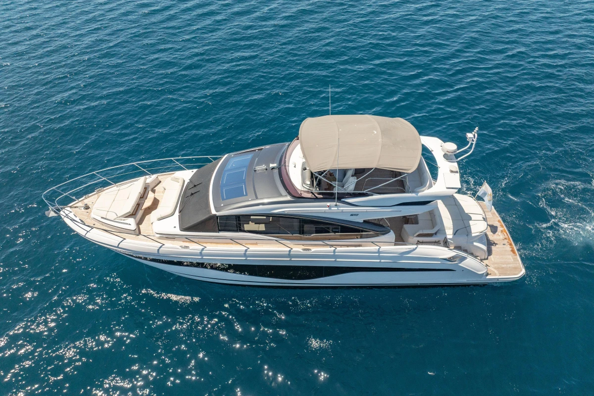 Luxurious 2023 Princess S62 yacht cruising on clear blue waters.