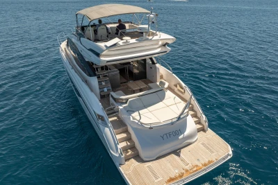 2023 Princess S62 yacht cruising on clear blue ocean waters.