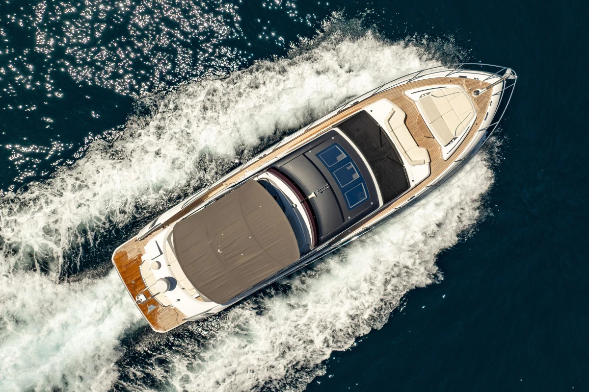 2023 Princess S62 yacht cruising on open water, aerial view.