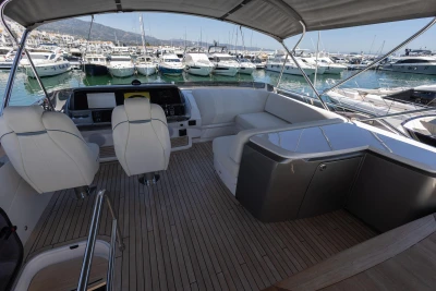 Luxurious 2023 Princess S62 yacht interior with elegant seating and marina view.