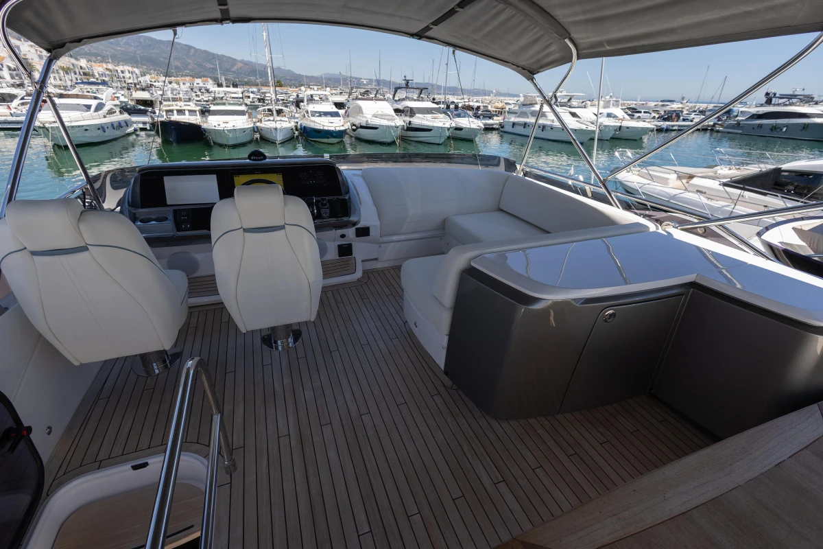 Luxurious 2023 Princess S62 yacht interior with elegant seating and marina view.