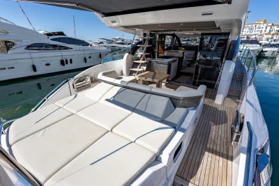 Luxurious 2023 Princess S62 yacht with spacious deck and modern interior at marina.