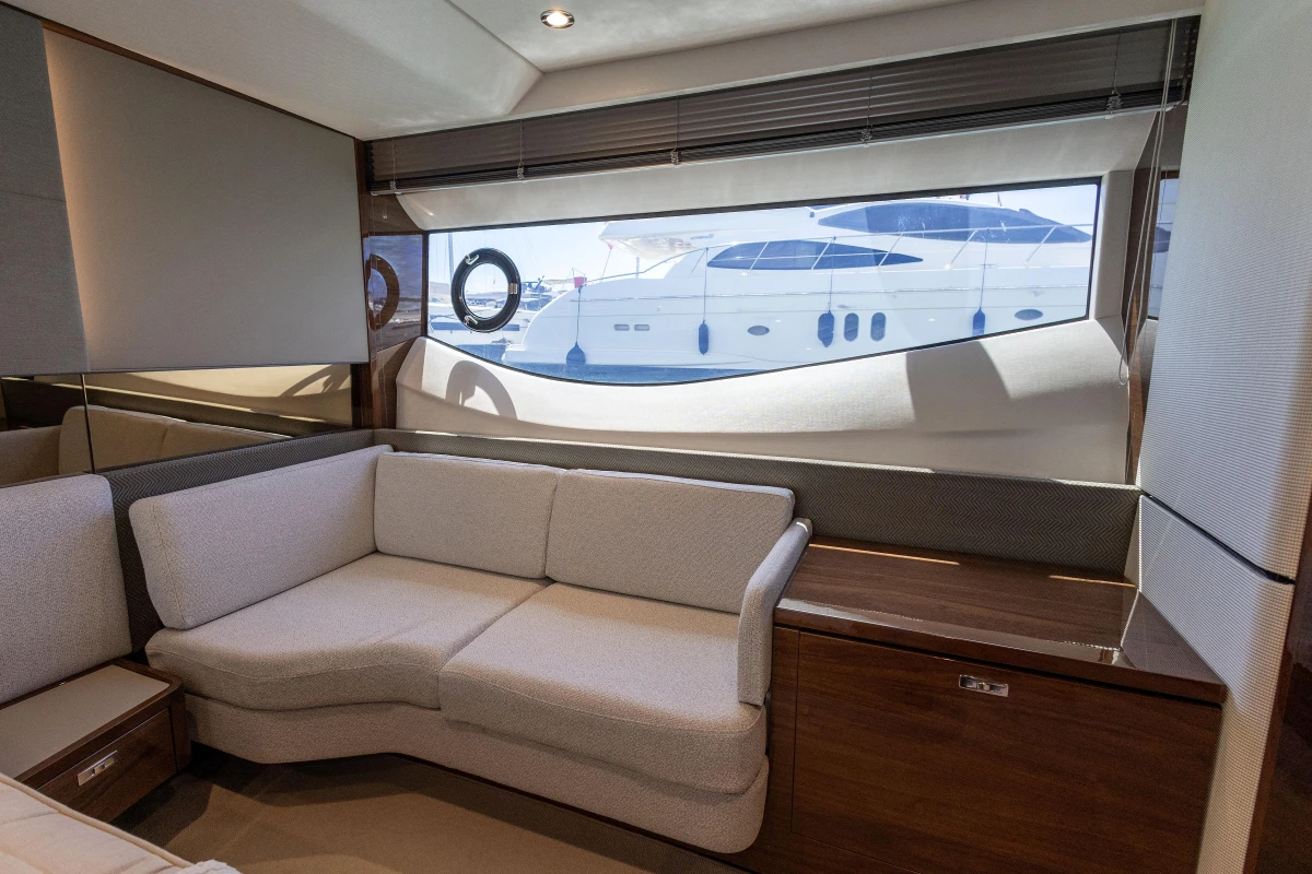 Luxurious interior of 2023 Princess S62 yacht with elegant seating and large window view.