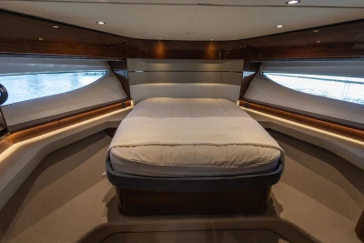 Luxurious 2023 Princess S62 yacht interior with elegant bed and modern design.