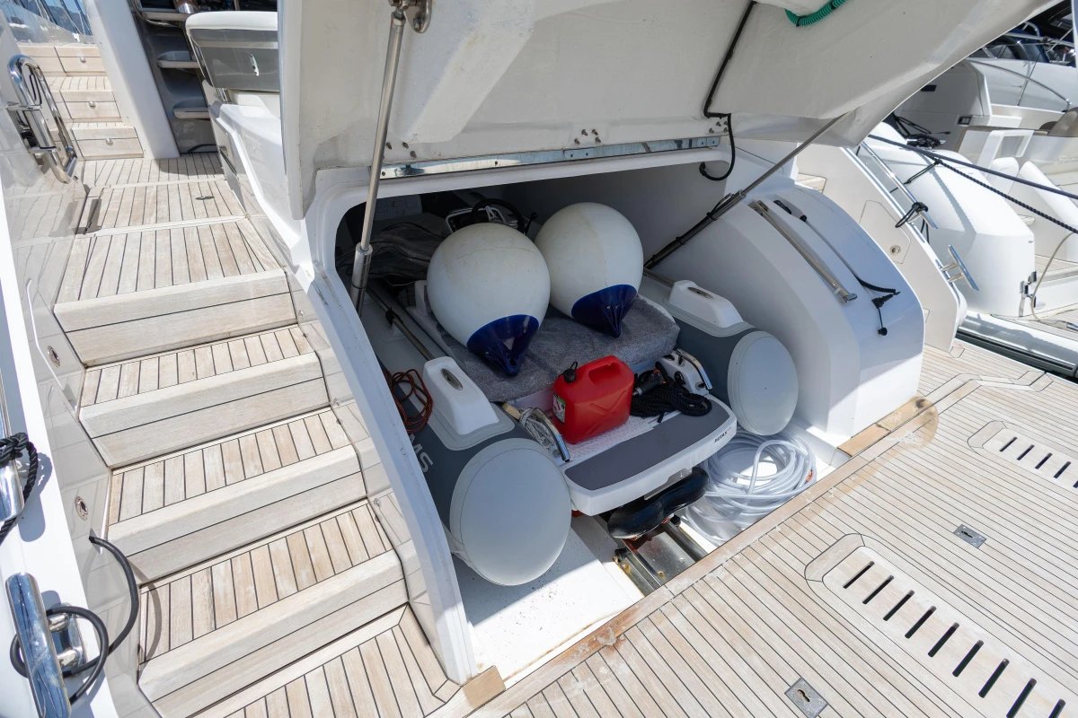 2023 Princess S62 yacht storage compartment with fenders and equipment on teak deck.