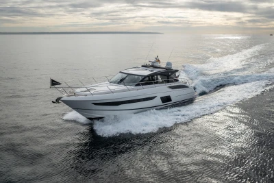 2016 Princess V58 Open yacht cruising on open water under cloudy skies.