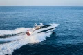 Luxurious 2025 Princess V55 yacht cruising on open sea, showcasing sleek design and performance.