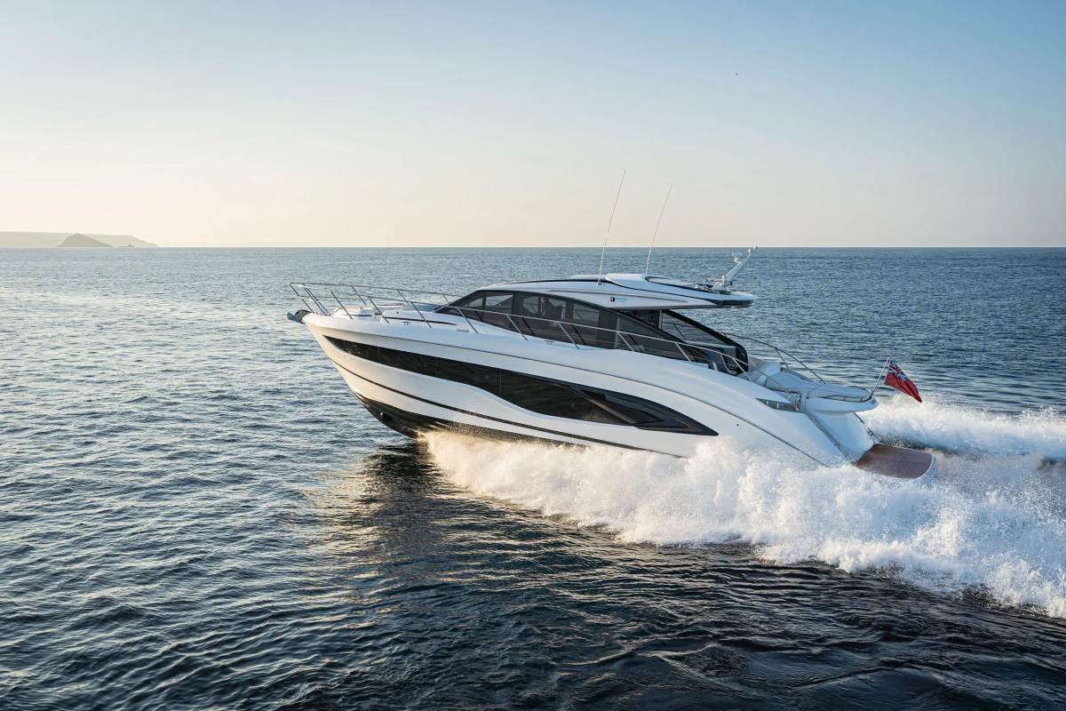 2025 Princess V55 yacht cruising on open sea at sunset.