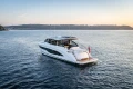 Luxurious 2025 Princess V55 yacht cruising on serene waters at sunset.