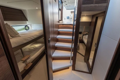 Interior of 2026 Princess V55 yacht with stairs and cabins.
