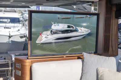 Luxury yacht Princess V55 2026 displayed on screen in modern interior.