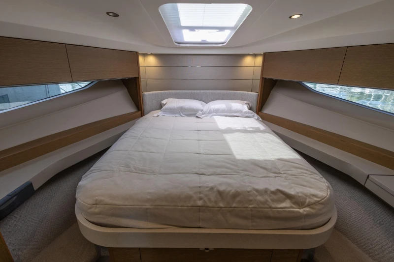 Luxurious bedroom interior of 2019 Princess V40 yacht with skylight and modern design.