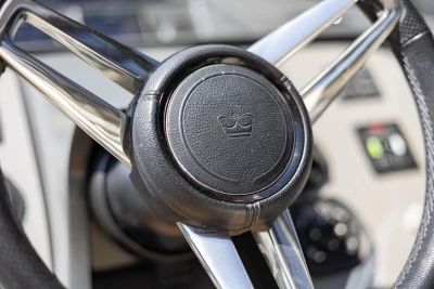 Steering wheel of a 2019 Princess V40 yacht, featuring a crown emblem.