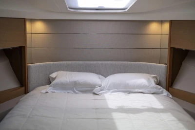 Luxurious bedroom interior of 2019 Princess V40 yacht with elegant lighting and cozy bedding.