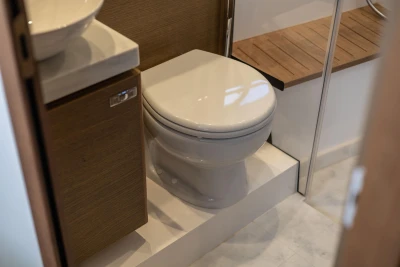 Modern bathroom in 2019 Princess V40 yacht with toilet and wooden accents.