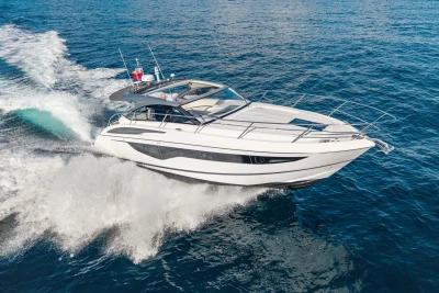 2019 Princess V40 yacht cruising on open sea, creating dynamic water splashes.