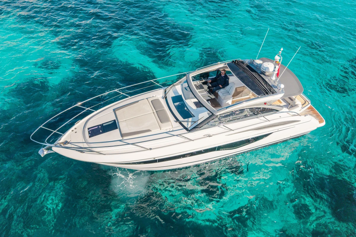 2019 Princess V40 yacht cruising on clear turquoise waters.