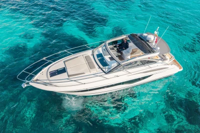 2019 Princess V40 yacht cruising on clear turquoise waters.