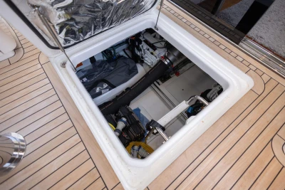 Engine compartment of 2024 Princess F50 yacht, showcasing mechanical components and storage.
