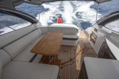 Luxurious 2017 Princess V48 Open yacht interior with elegant seating and wooden table.