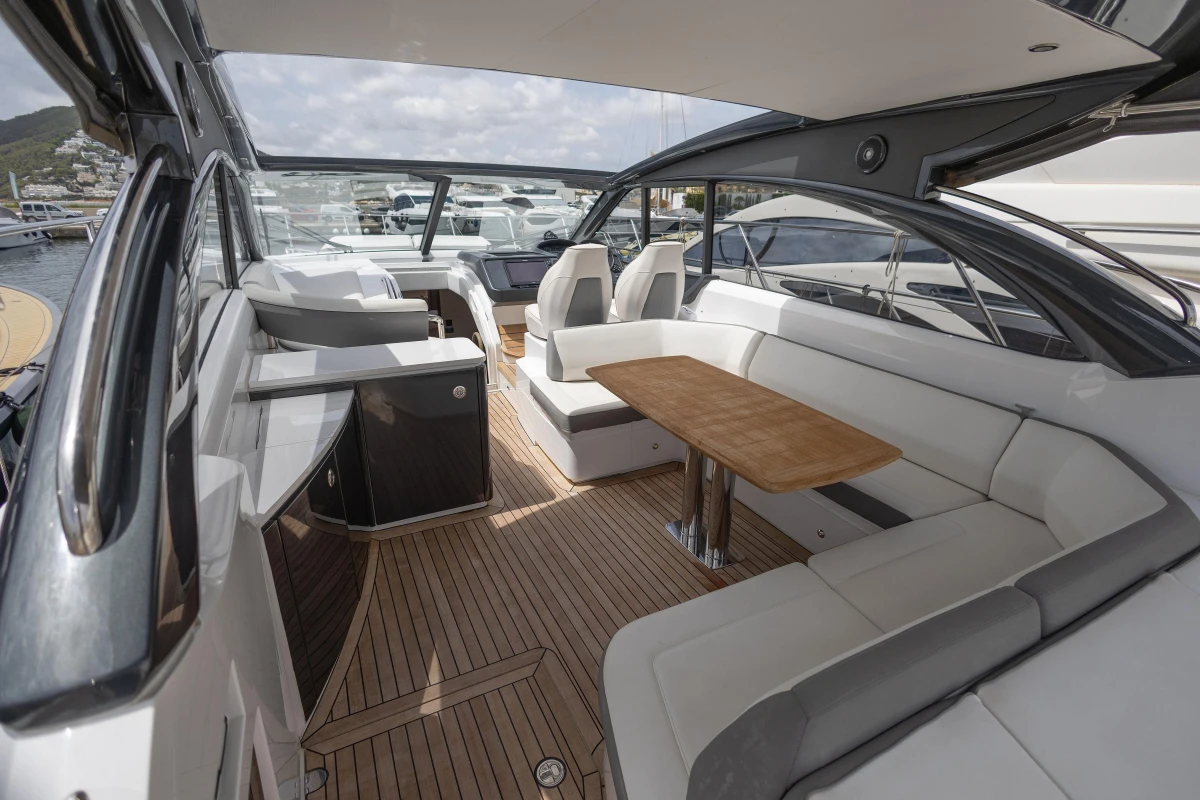 Luxurious 2017 Princess V48 Open yacht interior with elegant seating and wooden table.
