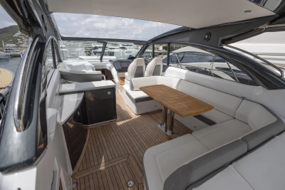 Luxurious 2017 Princess V48 Open yacht interior with elegant seating and wooden table.