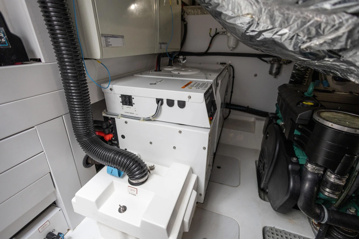 Engine room of 2017 Princess V48 Open yacht, featuring generator and mechanical components.