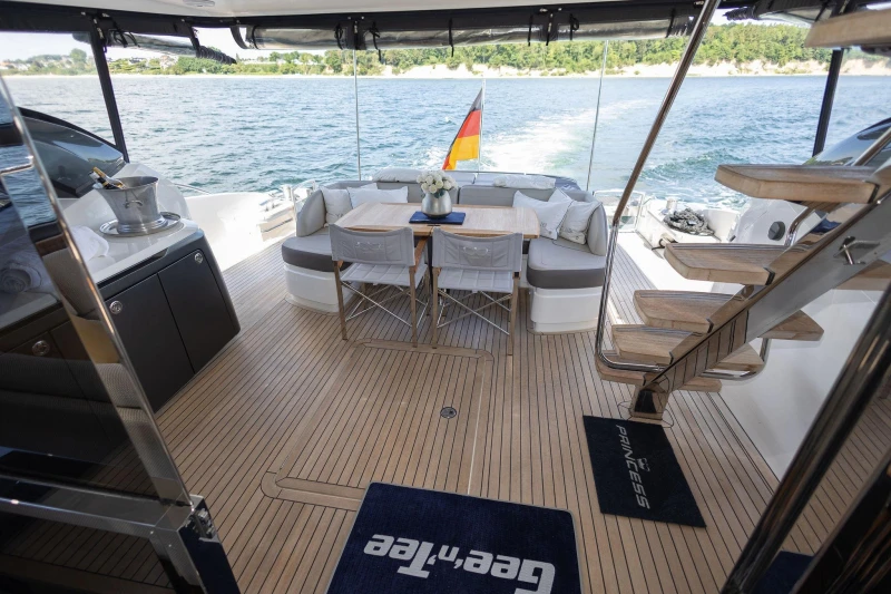 Luxurious 2014 Princess S72 yacht deck with elegant seating and scenic ocean view.