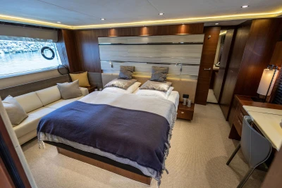 Luxurious 2014 Princess S72 yacht bedroom with elegant decor and scenic window view.
