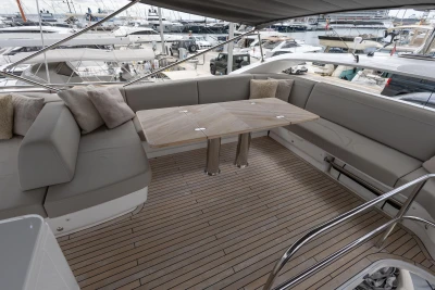 Luxurious 2023 Princess F55 yacht deck with elegant seating and wooden table.