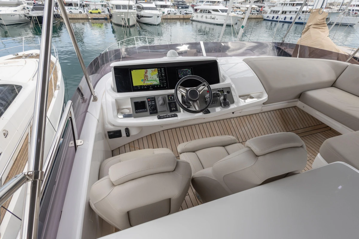 Luxurious 2023 Princess F55 yacht cockpit with modern navigation system and plush seating.