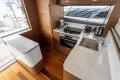 Luxurious kitchen interior of 2023 Princess F55 yacht with modern appliances and sleek design.