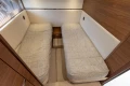 2023 Princess F55 yacht interior with twin beds and wooden accents.