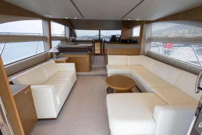 Luxurious interior of a 2014 Princess 56 yacht with elegant white seating and modern design.