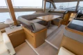 Luxurious interior of a 2014 Princess 56 yacht with elegant seating and dining area.