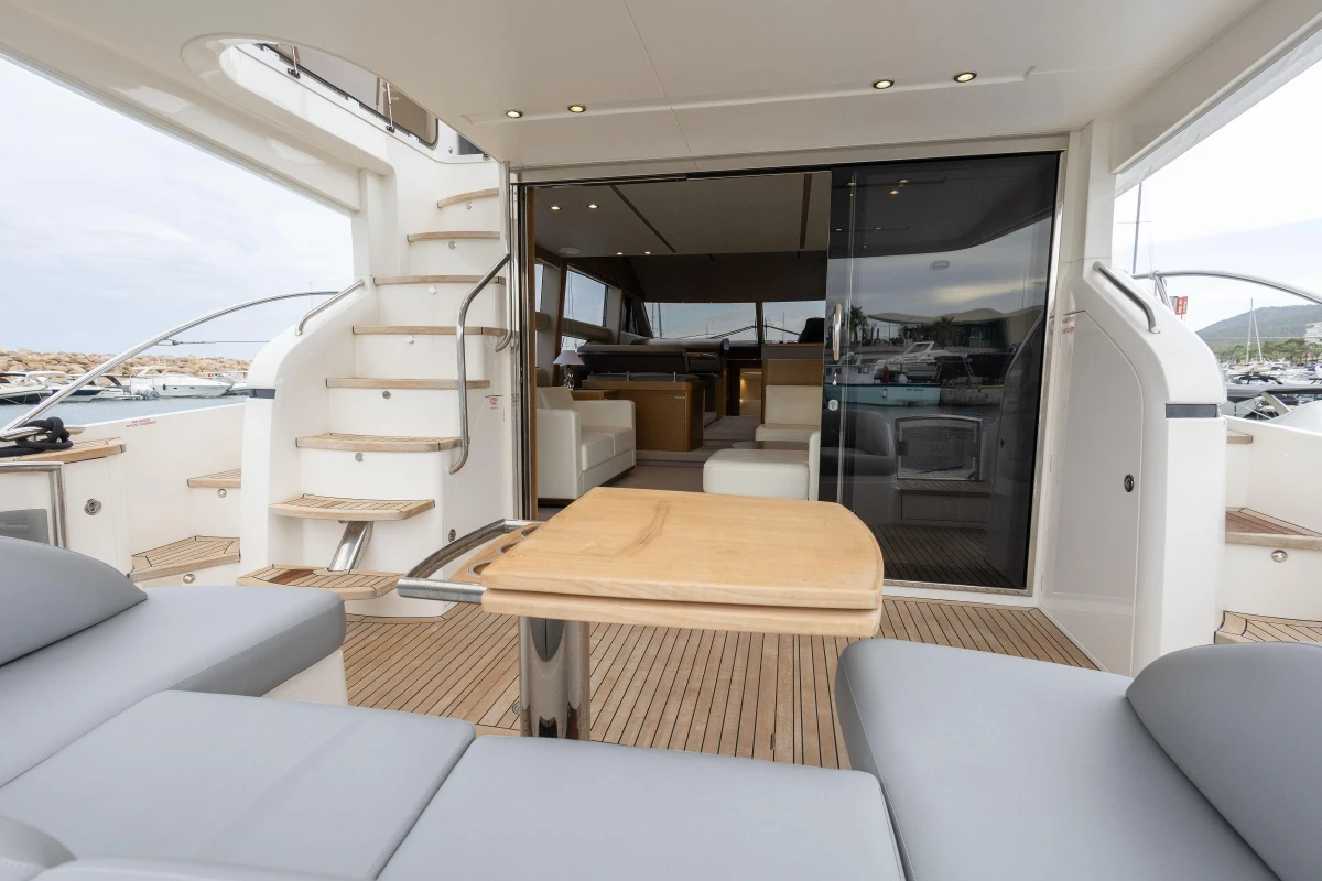Luxurious 2014 Princess 56 yacht interior with elegant seating and wooden table.
