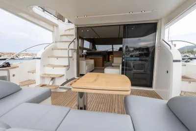 Luxurious 2014 Princess 56 yacht interior with elegant seating and wooden table.