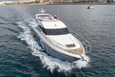 Luxurious 2014 Princess 56 yacht cruising on open water, showcasing sleek design and elegance.