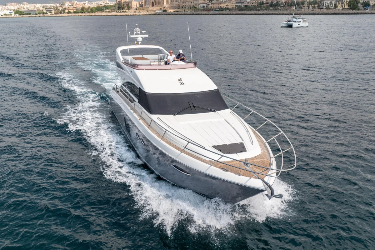 Luxurious 2014 Princess 56 yacht cruising on open water, showcasing sleek design and elegance.
