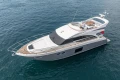 Luxurious 2014 Princess 56 yacht cruising on open water, featuring sleek design and spacious deck.