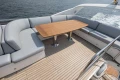 Luxurious 2014 Princess 56 yacht deck with elegant seating and wooden table.