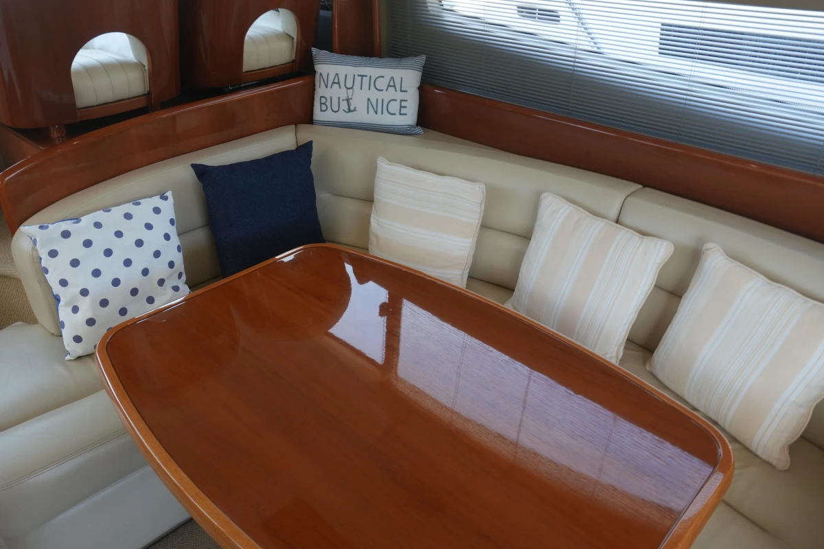 Luxurious interior of 2006 Princess 42 Flybridge Motor Yacht with elegant seating and cushions.